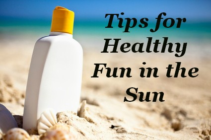 Bottle of suncreen on a sunny beach beside the ocean.